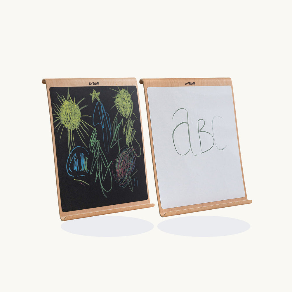 Two educational boards, one blackboard with drawings and one whiteboard with letters, on a white background.
