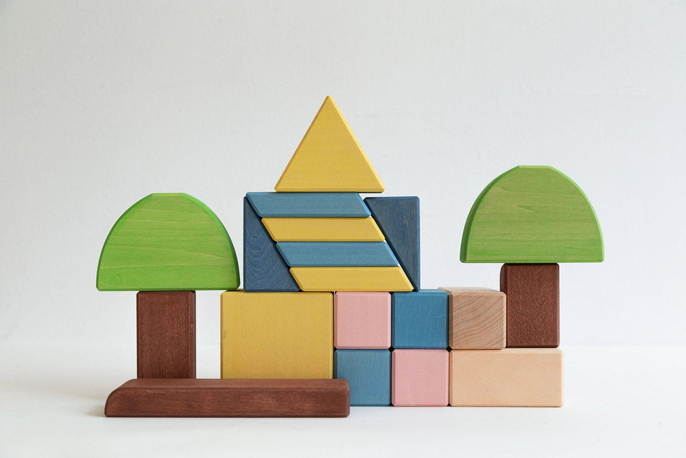 Wooden blocks stacked in the shape of trees and mountain