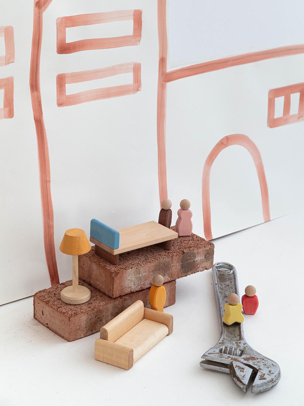 Miniature furniture on the blocks and spanner on the paining background