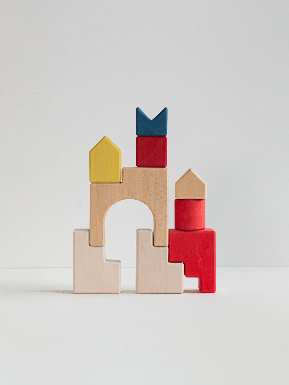 Colorful wooden building blocks on a light gray background