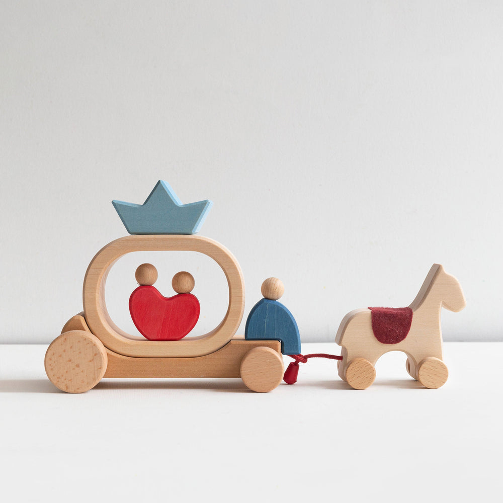 Wooden toy family with a horse on a white background