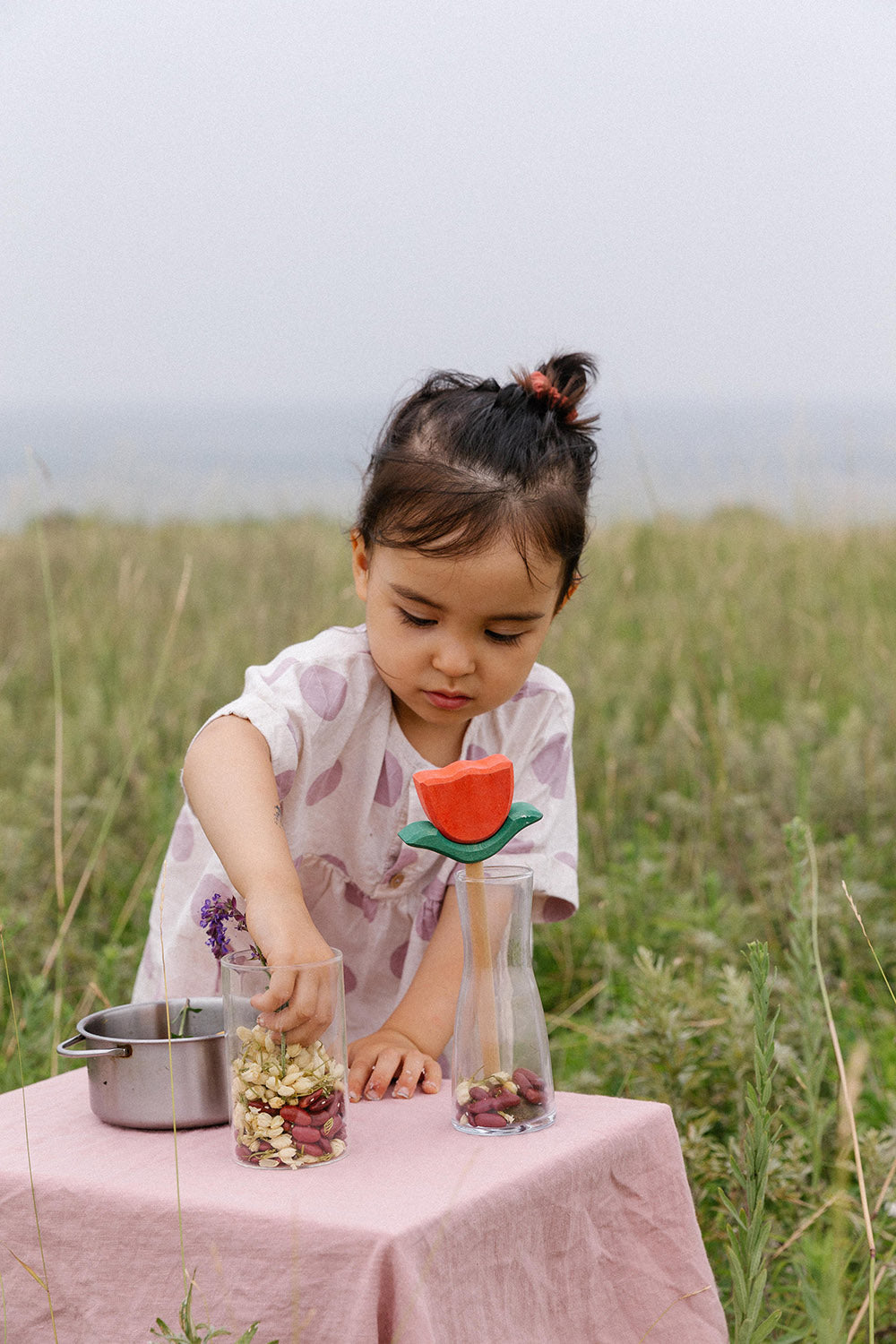 A wooden flower is placed in a glass vase