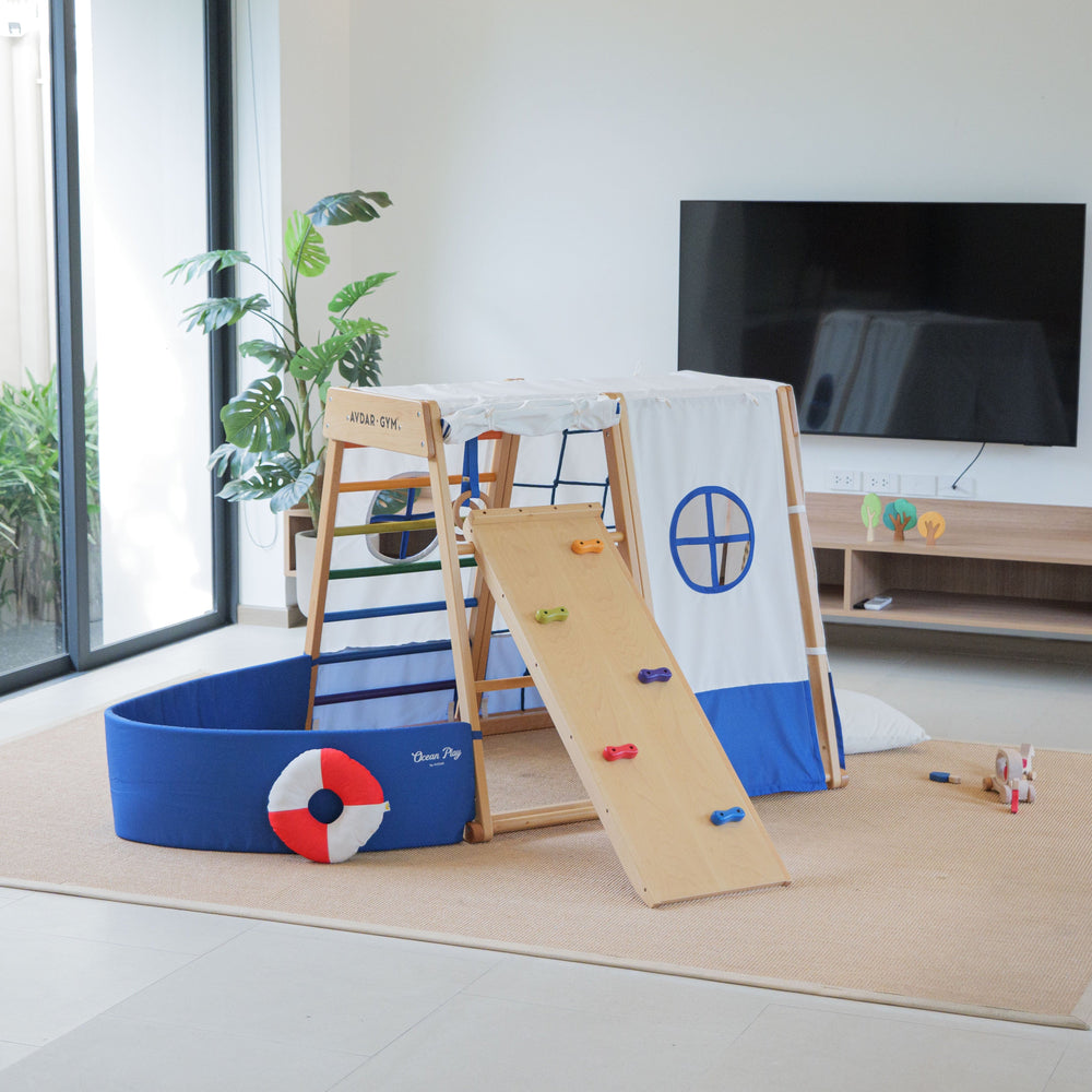 Children's play area with climbing structures and toys in a modern living room.