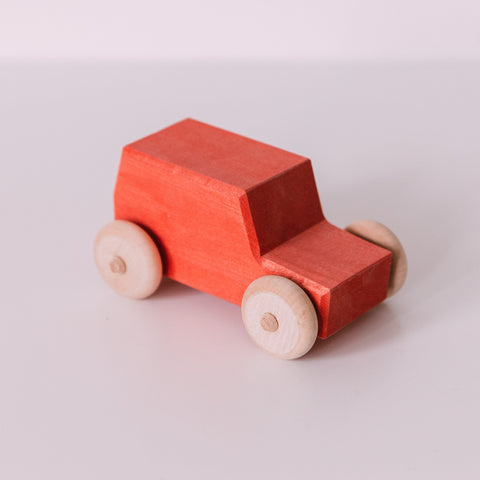 A small red wooden toy jeep with a beige finish and dark gray wheels, displayed on a white background.