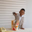 A boy open the transparent dust guard of multi-floor block set