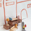 Miniature furniture on the blocks and spanner on the paining background