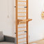 A wooden wall bar set with multiple rungs, mounted on a white wall, with a gray sofa to the left in a home environment.