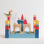 Colorful toy castle with dragon, king, queen and castle on a white background
