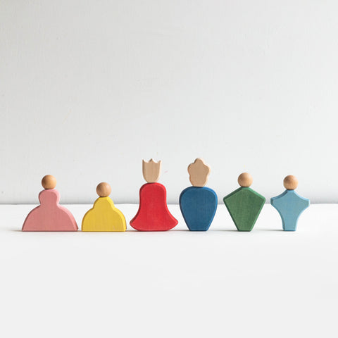 Set of colorful wooden peg dolls on a white background